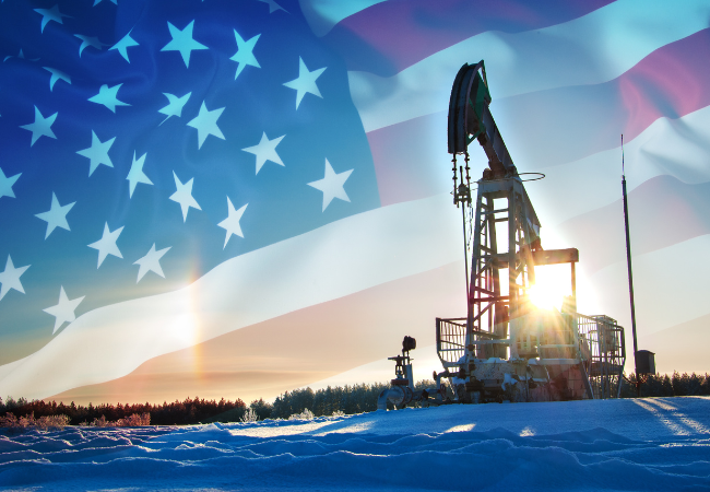 Immagine di una piattaforma petrolifera con lo sfondo di una bandiera americana.
