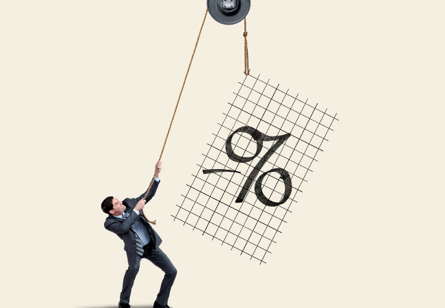 immagine di uomo d'affari che tira una corda attaccata a una gru mentre tenta di sollevare un grafico che indica tassi di interesse negativi