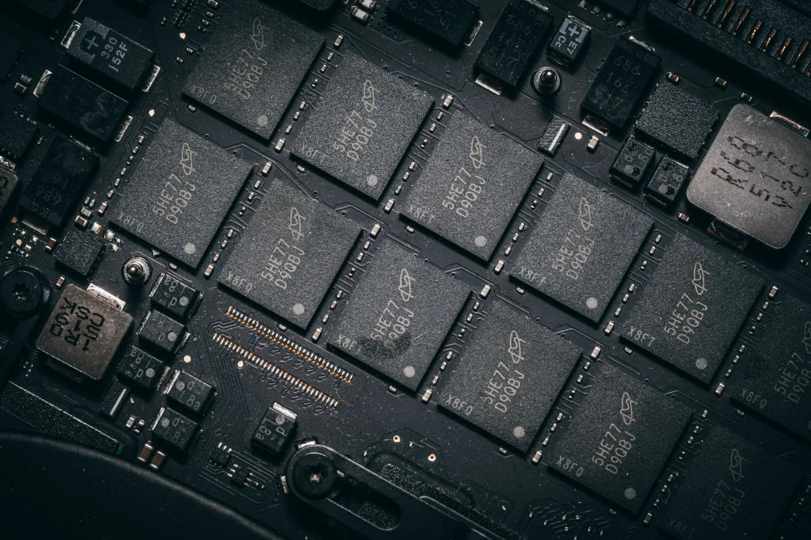 Detailed view of electronic circuit board components showcasing microchips and technology intricacies.