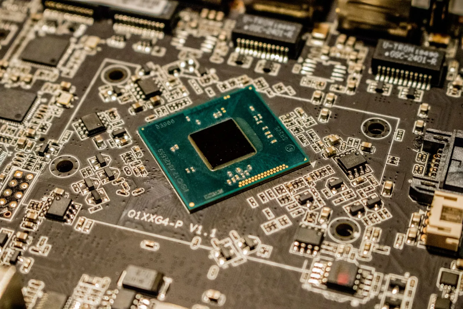 Detailed view of a microchip on a printed circuit board, showcasing electronic components.