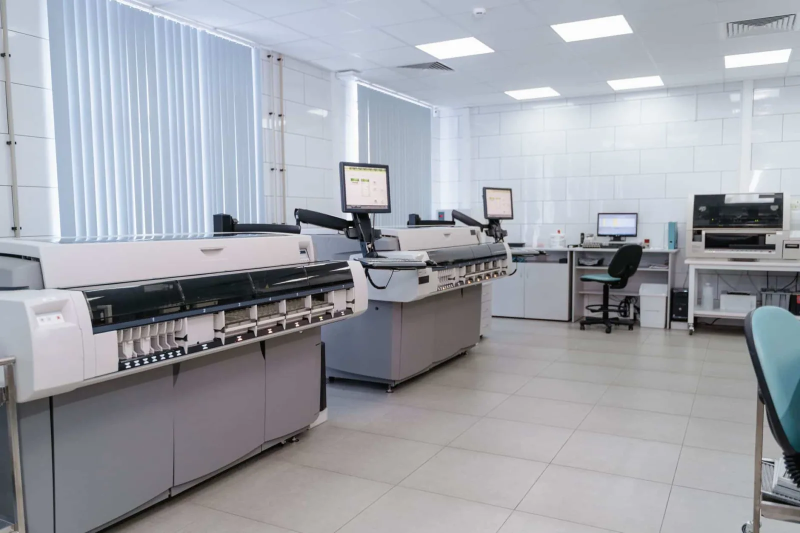 Spacious laboratory interior featuring state-of-the-art machines and computers for research purposes.