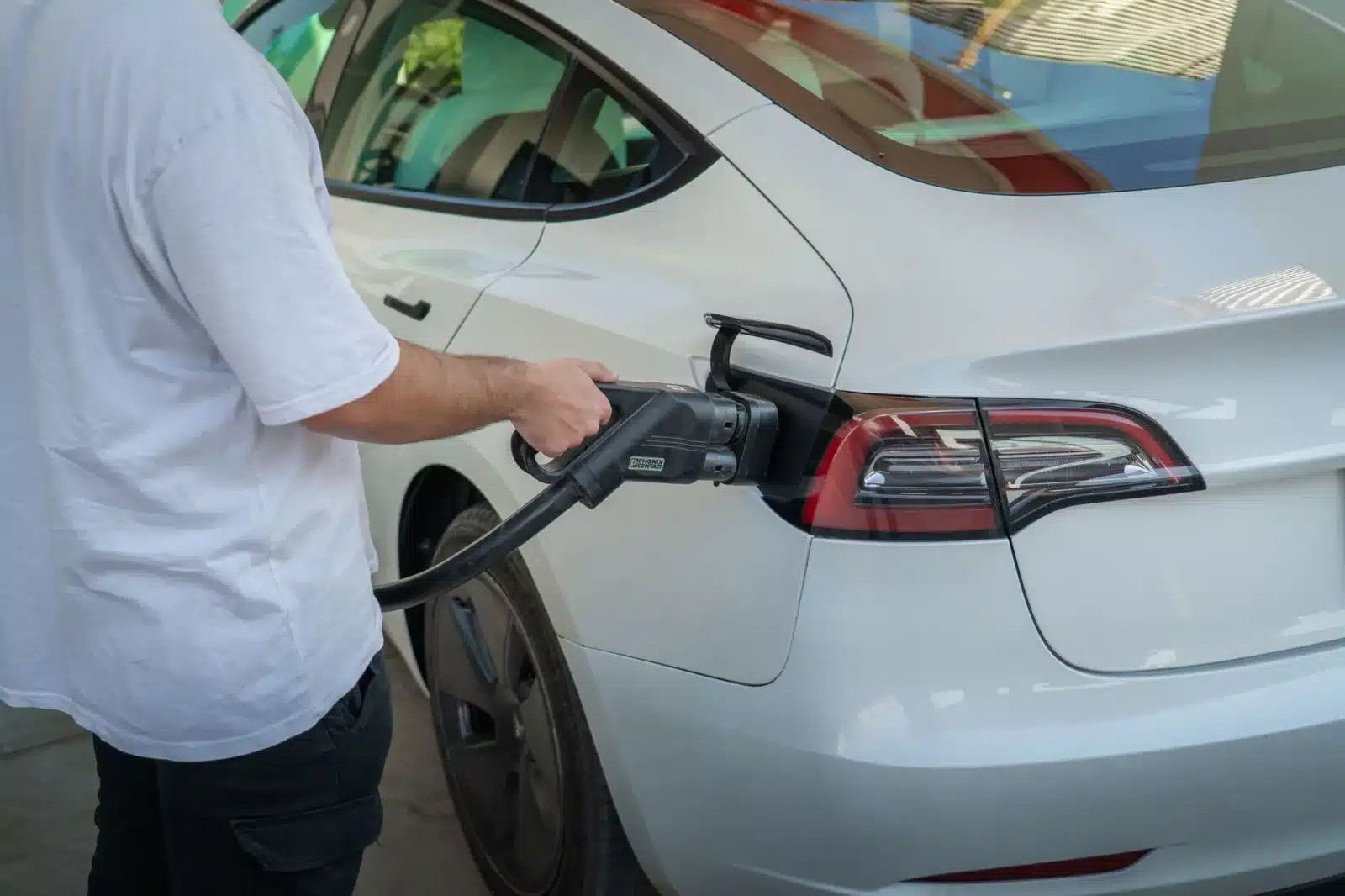 Electric car being charged at a station, highlighting eco-friendly transportation.