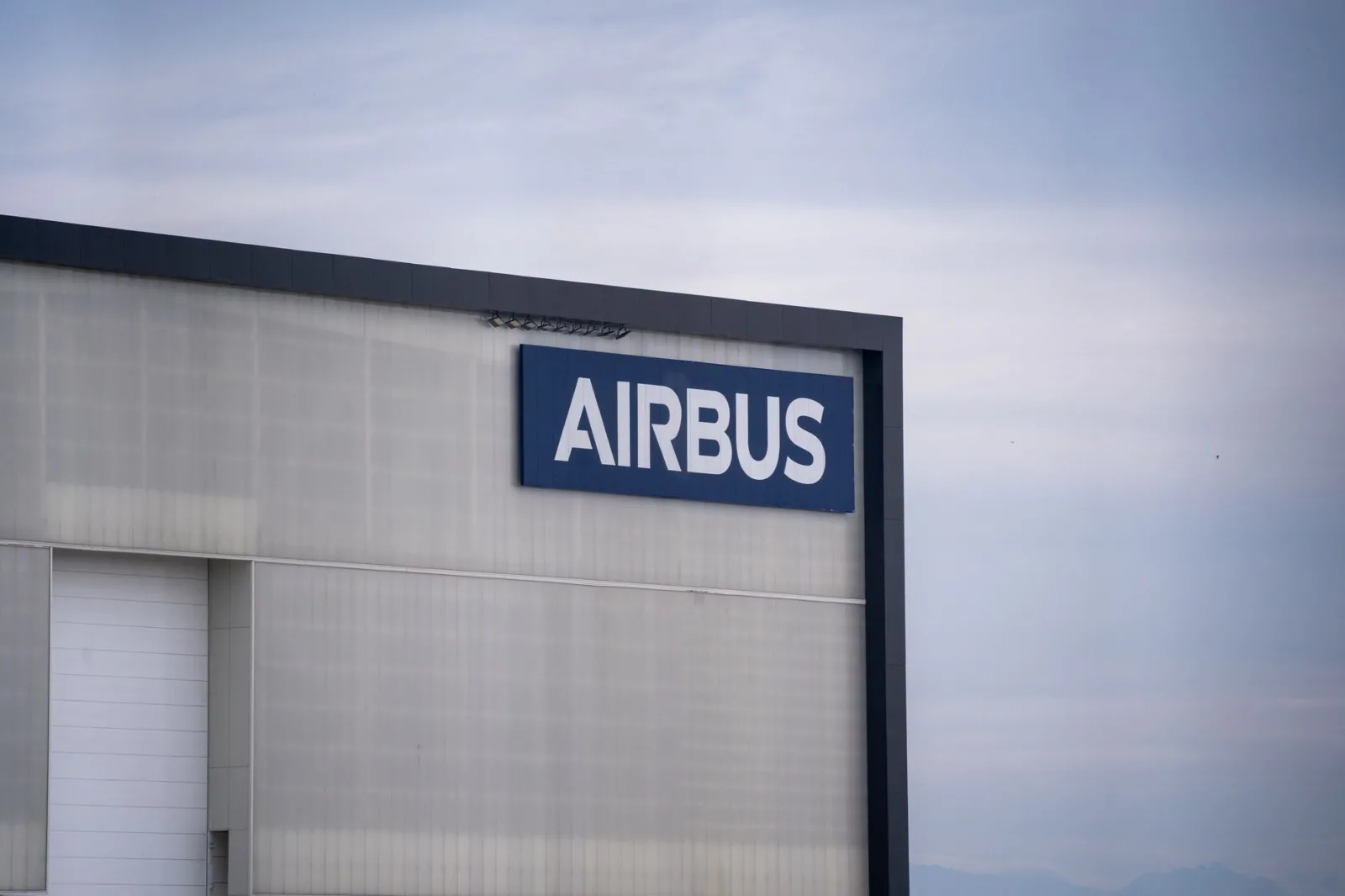 Exterior view of an Airbus factory building with the company logo prominently displayed.